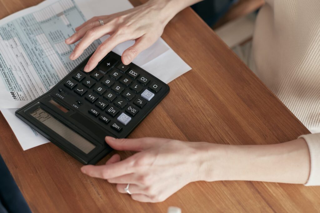 A person doing computations on a calculator