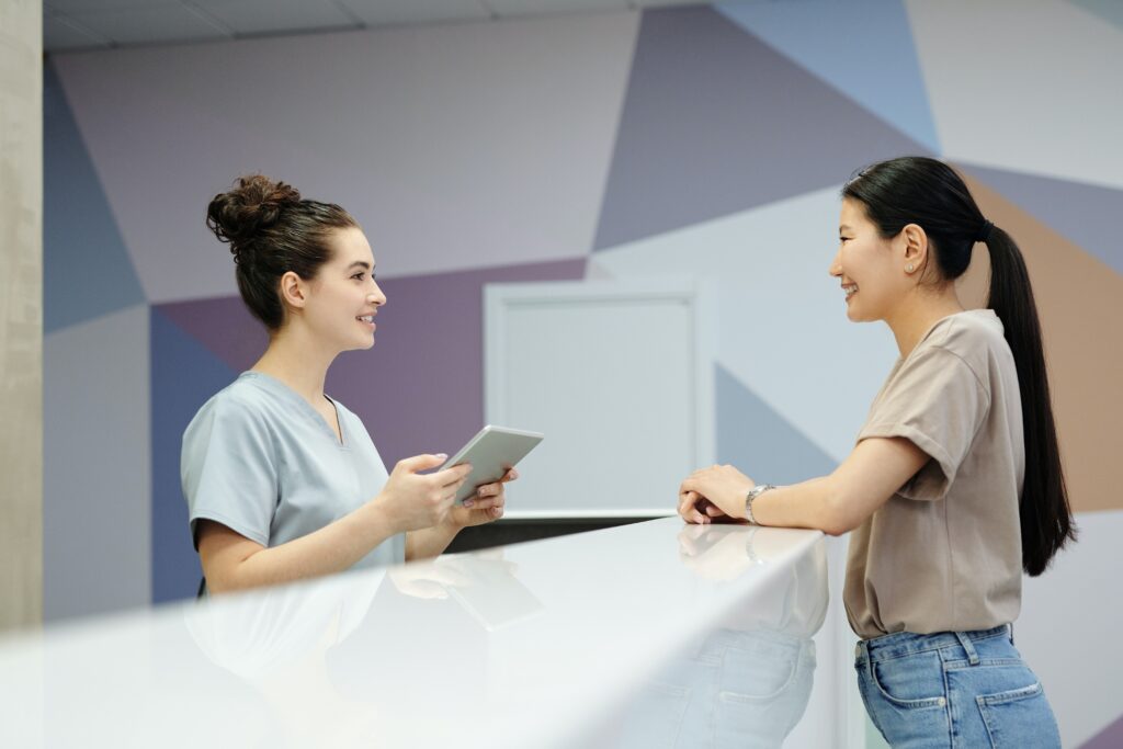 A patient talking to a receptionist