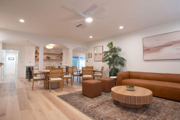 A bright open-concept living and dining space with natural wood accents and modern decor.
