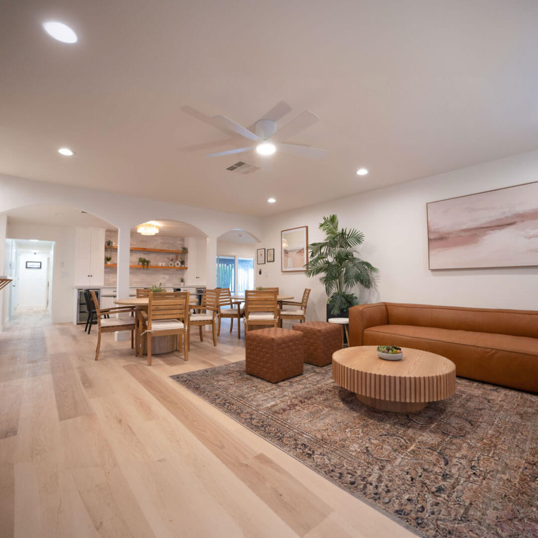 A bright open-concept living and dining space with natural wood accents and modern decor.