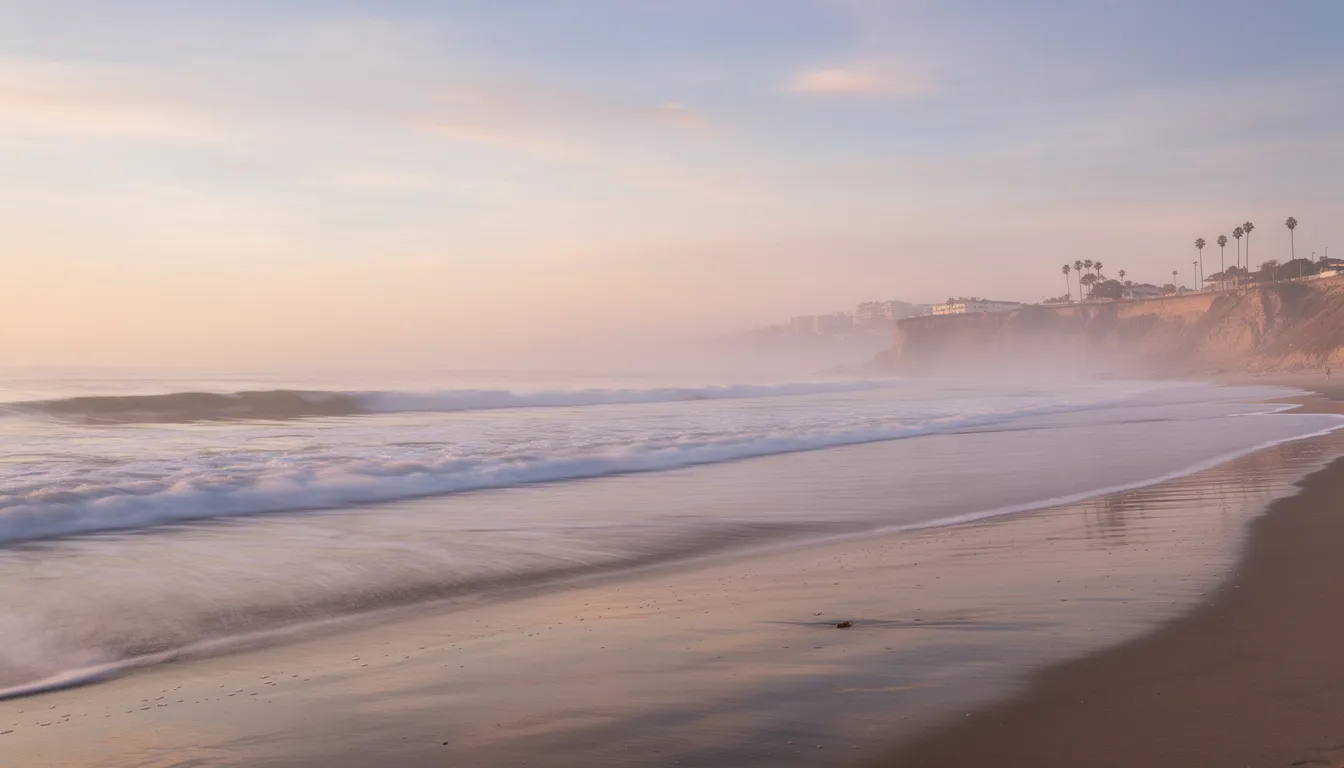 The image depicts serene ocean waves gently lapping against the Southern California coastline at dawn, creating a tranquil atmosphere that symbolizes peace and renewal, akin to the recovery journey in addiction treatment. This peaceful scene reflects the hope and healing found in supportive environments such as alcohol rehab centers, where individuals can embark on their path to lasting recovery.